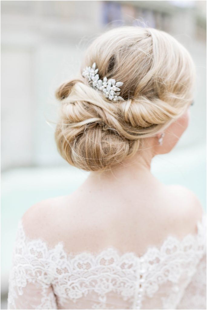 gorgeous bride with up-do on weding day with floral hair clip and lace wedding drace in morristown new jersey