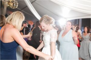 bride enjoys dancing with her friends at the wedding