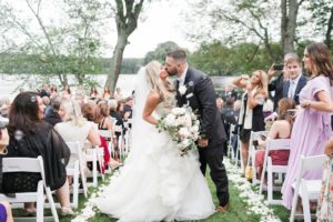 bride and groom just married kissing in the aisle at wedding ceremony at indian trail club franklin lakes nj
