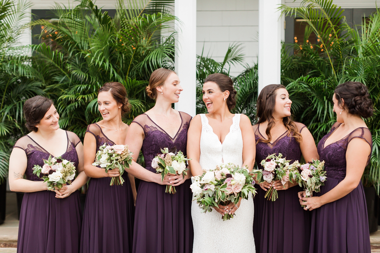 plum colored bridesmaid dresses with lavender and white floral bouquets