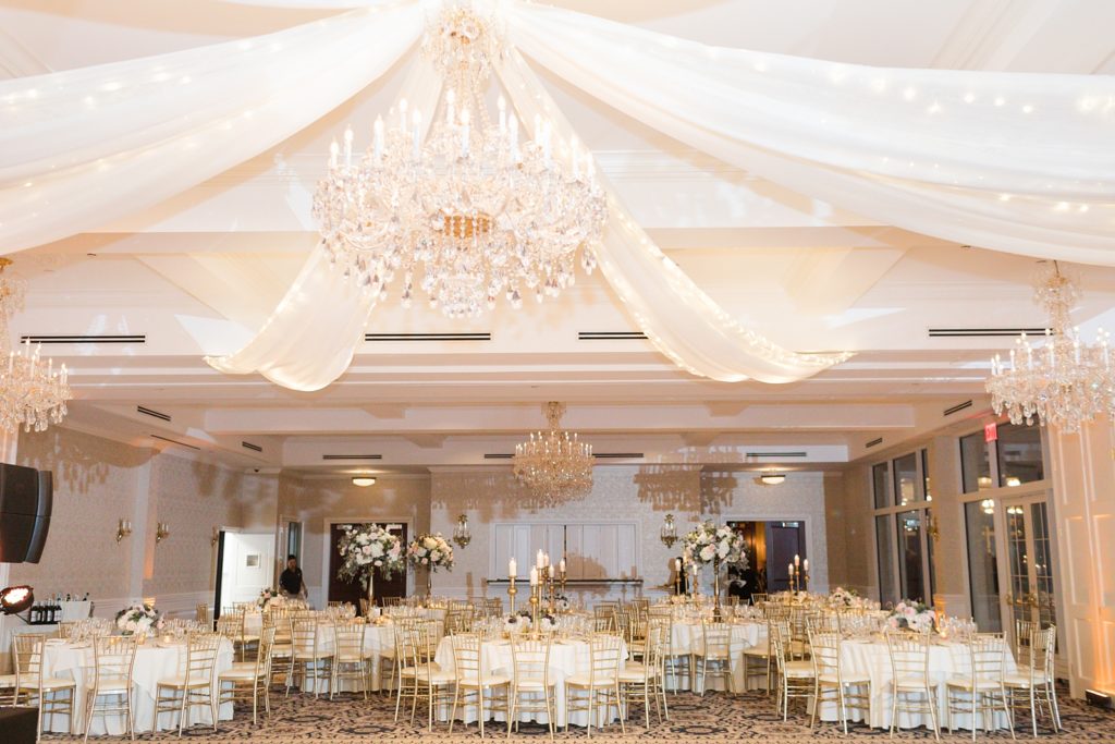gold and white sparkle and elegant wedding reception at the Trump National Golf Club Westchester with big crystal chandelier