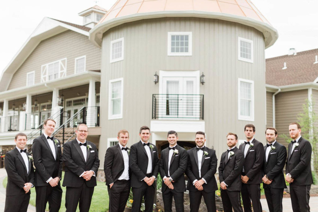 groomsmen in black tuxes at Bear Brook Valley