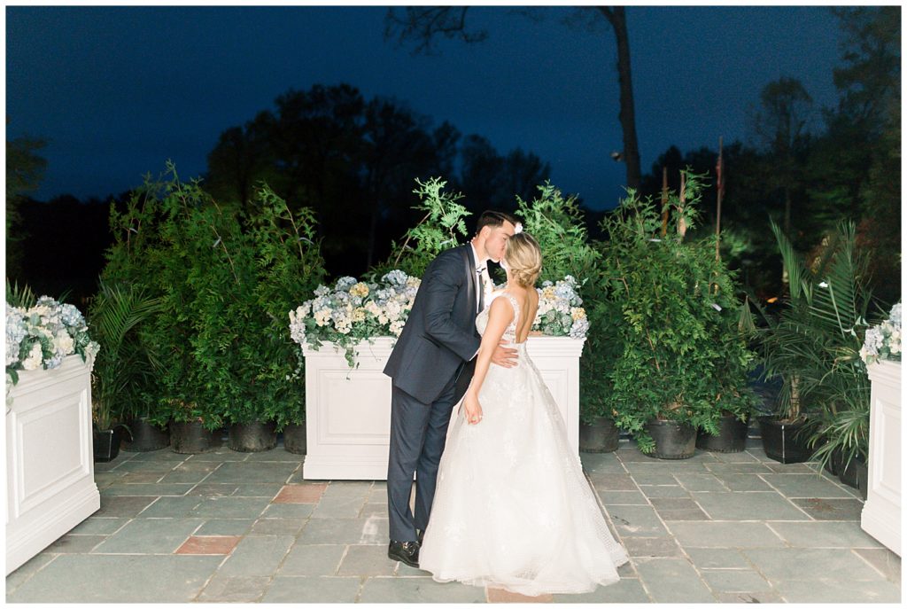 bride and groom kissing outside their wedding reception venue at eagle oak country club in new jersey
