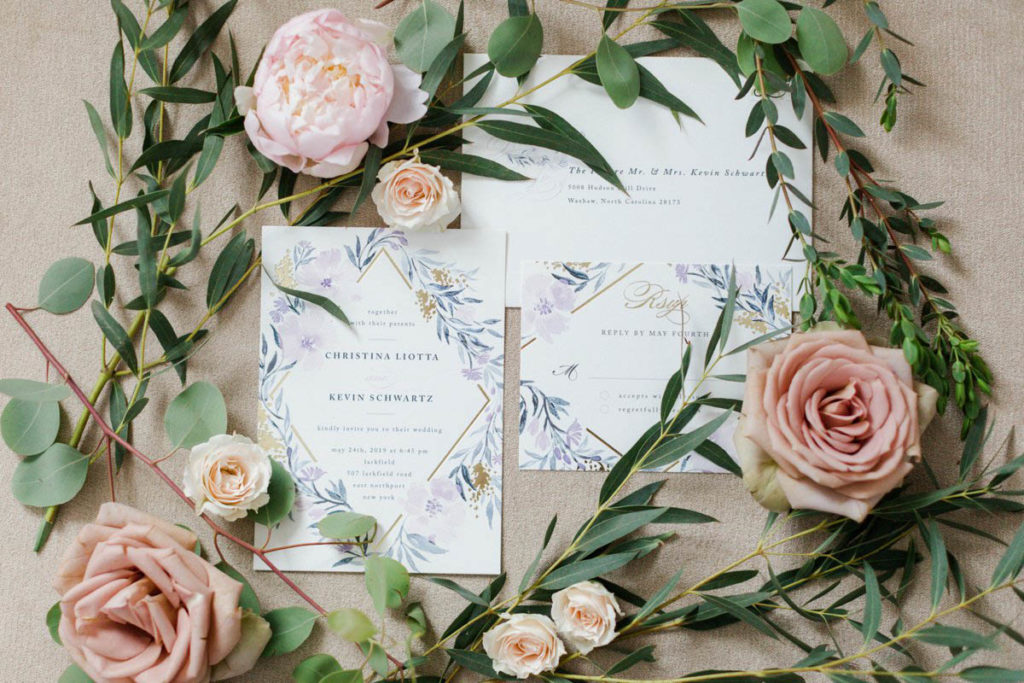 Minted wedding invitations surrounded by florals