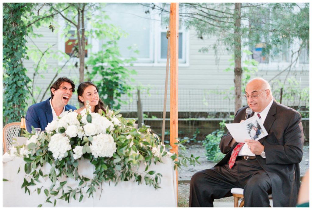 Backyard wedding tented reception toast