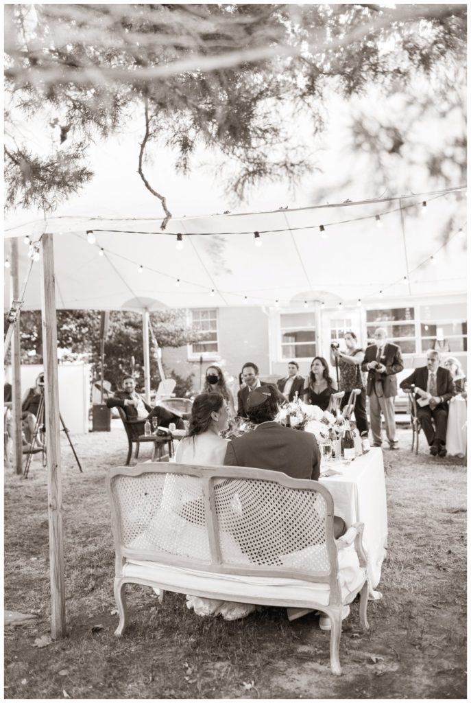 Backyard wedding tented reception toast